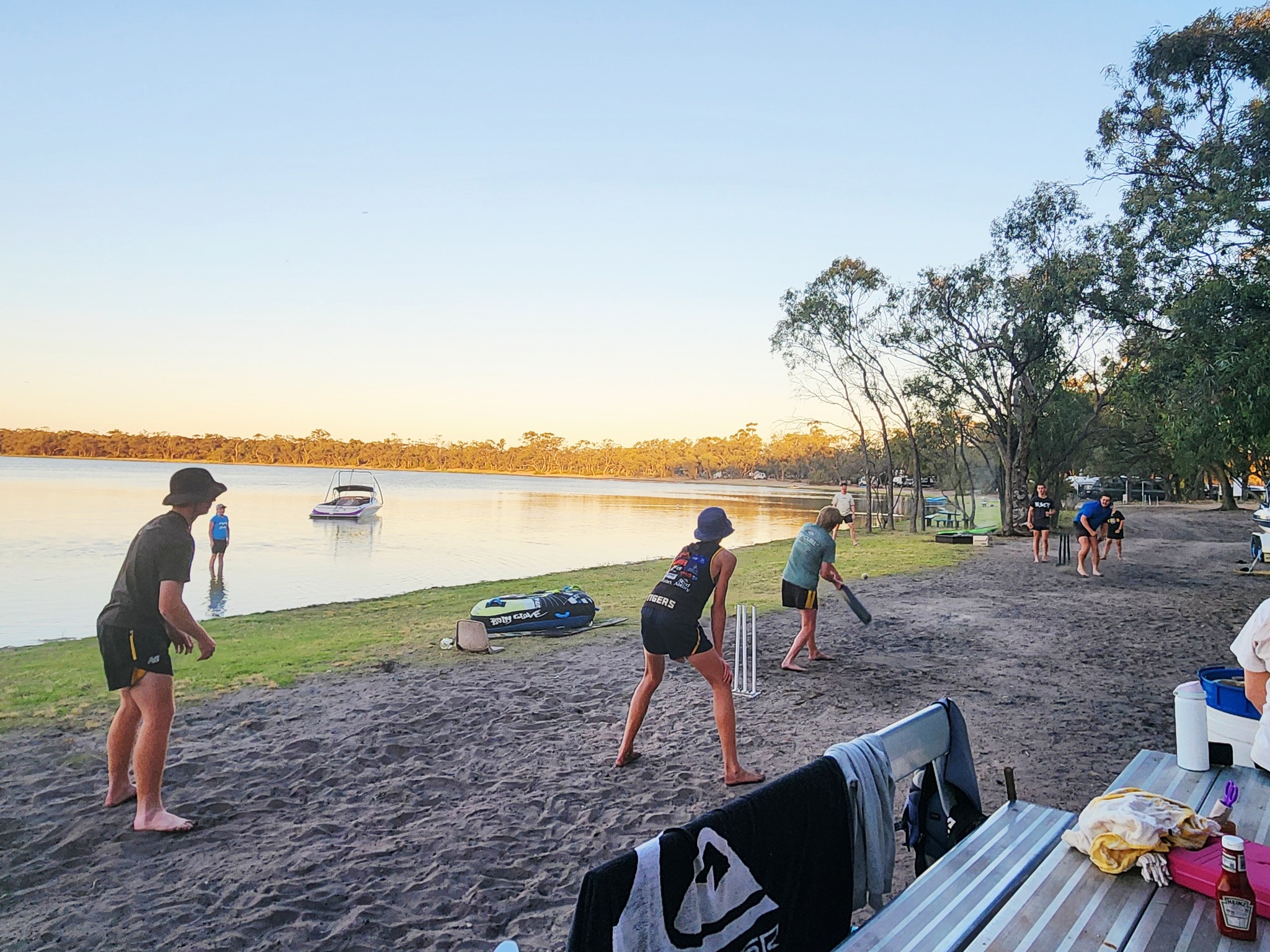 People playing cricket beside Green Lake
