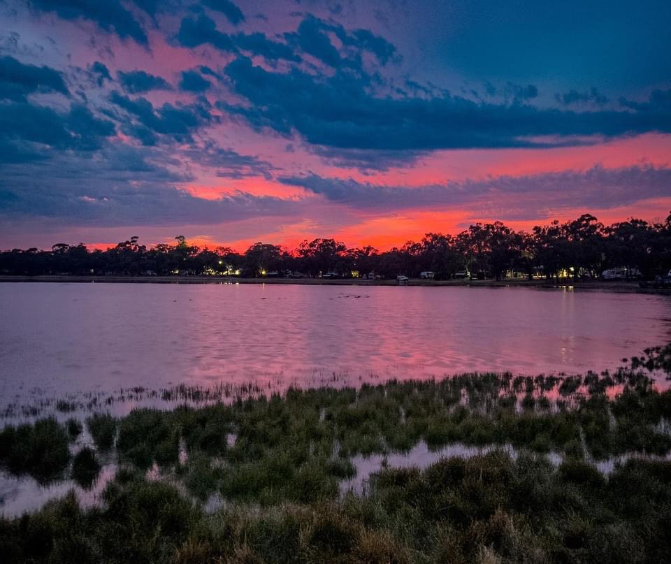 Purple and red sunset reflected over the lake